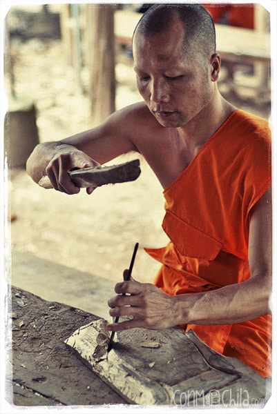 Monk carving wood at Wat Xieng Muan
